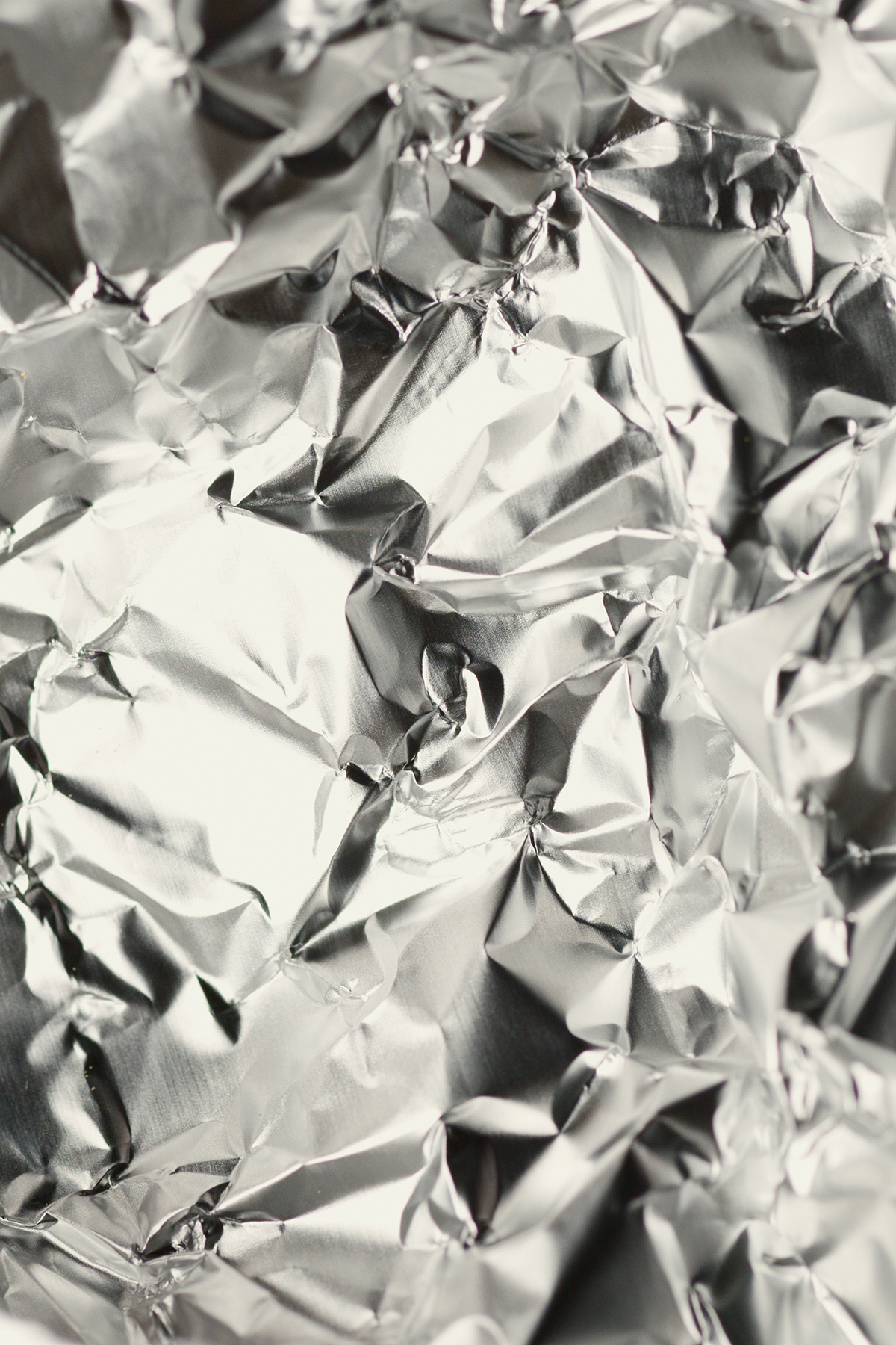 a close up of shiny, wrinkled aluminum foil.