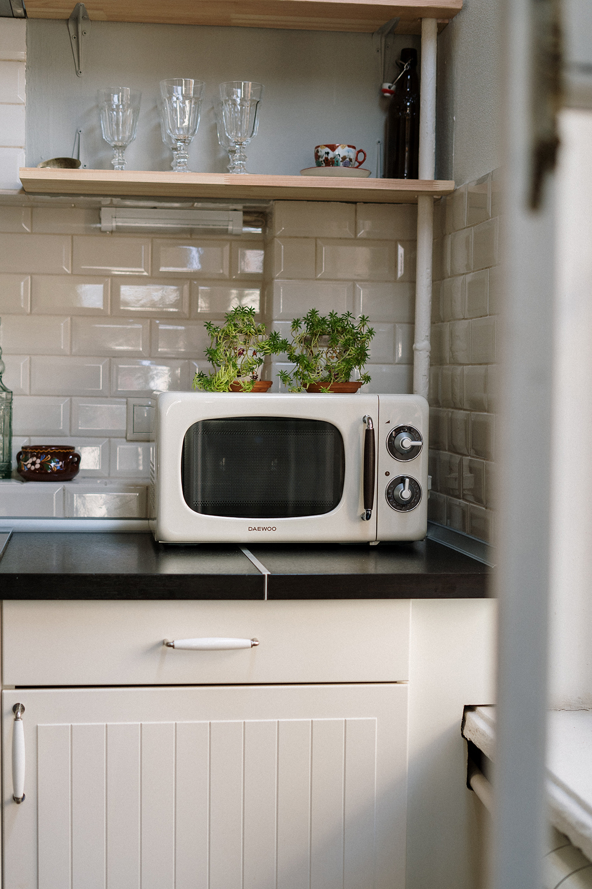 a white microwave on a black kitchen counter.