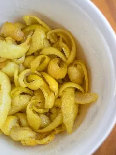 a bowl of lemon peels and their syrup.